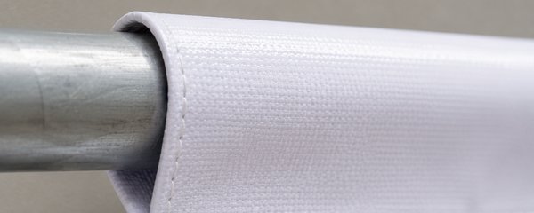 Close-up of a banner's top pocket sleeve with a pipe inserted through it